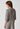 Rückansicht von einem Damen-Model, das HU taupe grey melange modal/viskose/tencel Shirt kurzarm trägt