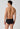 Rückansicht von einem Herren-Model, das HU black baumwolle Slip mit Eingriff Doppelpack trägt