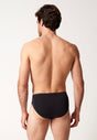 Rückansicht von einem Herren-Model, das HU black baumwolle Slip 3er Pack trägt