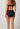 Rückansicht von einem Damen-Model, das HU black mikrofaser Maxi Slip trägt