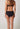 Rückansicht von einem Damen-Model, das HU black mikrofaser Midi Slip trägt