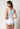 Rückansicht von einem Damen-Model, das HU white baumwolle Tanktop trägt