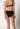 Rückansicht von einem Damen-Model, das HU black mikrofaser Midi Slip Doppelpack trägt